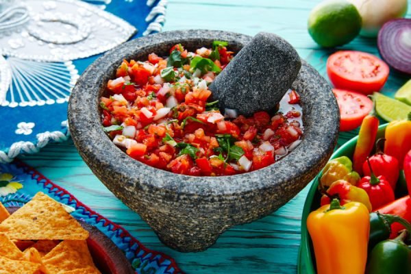 Pico de Gallo sauce from Mexico with tomato cilantro and onion in molcajete